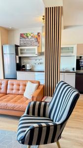 a living room with a couch and a chair at Apartment Mira in Ružomberok