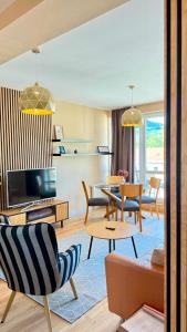 a living room filled with furniture and a tv at Apartment Mira in Ružomberok