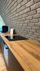 a counter in an office with a brick wall at Mia A-Frame Chalet Cheia in Cheia