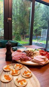 a wooden table with a plate of food on it at Mia A-Frame Chalet Cheia in Cheia +15 photos