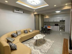 a living room with a couch and a table at Appartements Rebero Hills in Kigali