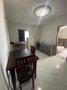 a dining room with a table and chairs and a television at Hotel Panorama do Mar - Praia do Futuro in Fortaleza