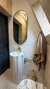 a bathroom with a sink and a mirror at Mia A-Frame Chalet Cheia in Cheia