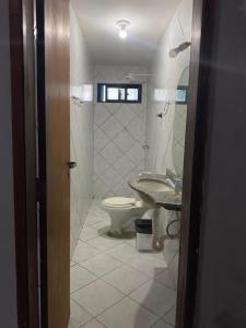 a bathroom with a toilet and a sink at Hotel Panorama do Mar - Praia do Futuro in Fortaleza
