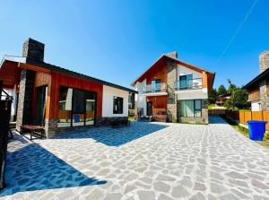 a house with a stone patio in front of it at Bakuriani - Happy Yard in Bakuriani