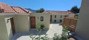 a pair of houses with brown doors in a yard at Calm And Nature in Petra