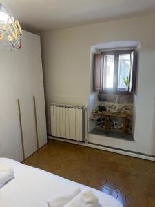 a bedroom with a bed and a window and a table at La Finestra Sul Paese in Pescocostanzo