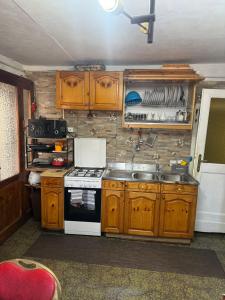 a kitchen with a stove and a sink in it at La Finestra Sul Paese in Pescocostanzo