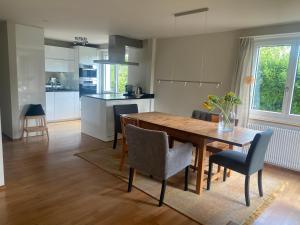 a kitchen and dining room with a wooden table and chairs at Charming House In Herrliberg in Herrliberg