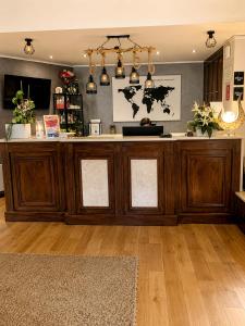 a large wooden counter in a room with wood floors at Hotel Taormina Brussels Airport in Zaventem