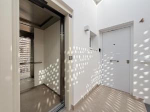a hallway with a door and a window at Villa Julia Apartamentos in Chipiona