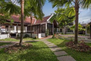 a house with palm trees in front of it at La palm Luang prabang in Luang Prabang