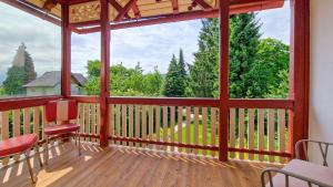a screened in porch with a view of the woods at Villa Bella Vita in Seeboden