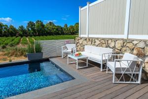 a patio with a pool and chairs next to a wall at סוויטת רגעים Regaim צימר בוטיק בגליל העליון in Sede Eli‘ezer