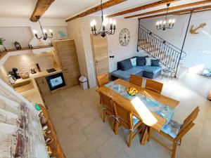 a living room with a table and a blue couch at Holiday House - OLD QUEEN in Šmrika