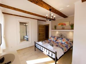 a bedroom with a bed and a mirror at Holiday House - OLD QUEEN in Šmrika