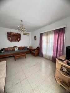 a living room with a couch and a window at Spacious villa for holidays in Kerkouene