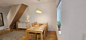 a dining room with a wooden table and chairs at Stora Beddinge - Moon apartment in Klagstorp
