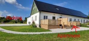 a barn with solar panels on the side of it at Stora Beddinge - Moon apartment in Klagstorp