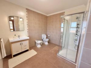 a bathroom with a toilet and a sink and a shower at Casa Lua Guesthouse in Burgau +31 photos