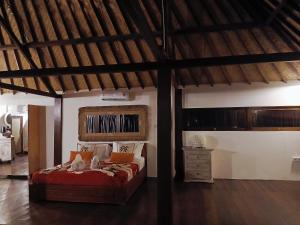 a bedroom with a bed and a wooden ceiling at My happy place loft gili air in Gili Islands
