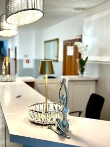 a table with a candle in a bowl on it at Hotel Natura Centrum Zdrowia in Duszniki Zdrój