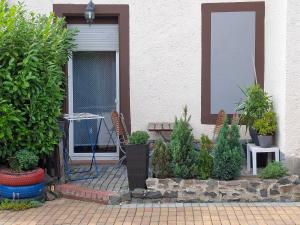 a house with a porch with a bunch of plants at Altes Forsthaus Zwenkau in Zwenkau