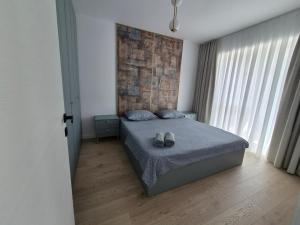a bedroom with a bed with two shoes on it at Apartament Nagiulia in Oradea