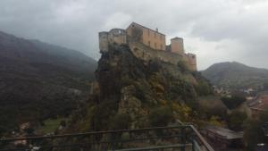 a castle on the top of a mountain at A casa di catharina appartement in Zicavo +2 photos