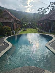 a swimming pool in front of a house at Mandala Home Villa in Culik