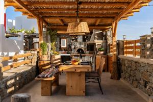 an outdoor patio with a wooden table and chairs at Boriadon Rustic Countryside Homes in Naxos Chora