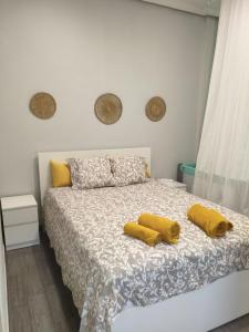 a bedroom with a bed with two yellow pillows on it at El Molar Loft in El Molar