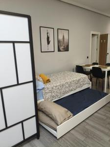 a bedroom with a bed and a mirror at El Molar Loft in El Molar