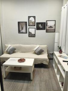 a room with a bed and a table and pictures on the wall at El Molar Loft in El Molar +14 photos