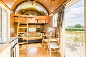 a tiny house with a bunk bed and a balcony at 1 Bed in Elsing oc-d44228 in Elsing