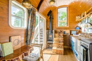 a kitchen with wooden walls and windows and a stove at 1 Bed in Elsing oc-d44228 in Elsing