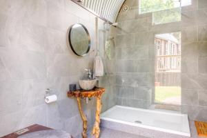 a bathroom with a tub and a mirror at 1 Bed in Elsing oc-d44228 in Elsing