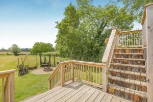 a wooden deck with a staircase leading to a yard at 1 Bed in Elsing oc-d44228 in Elsing +16 photos