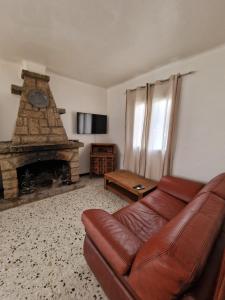a living room with a couch and a fireplace at A casa di catharina appartement in Zicavo