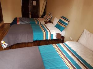 Postel nebo postele na pokoji v ubytování Hostal Buenos Aires