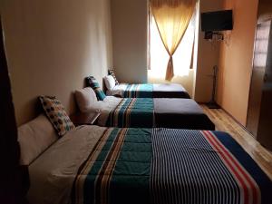 Postel nebo postele na pokoji v ubytování Hostal Buenos Aires