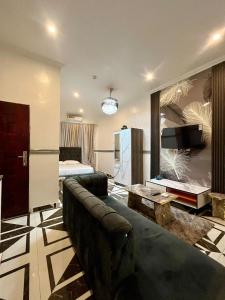 a living room with a couch and a bed at Luxury studio apartment in Accra