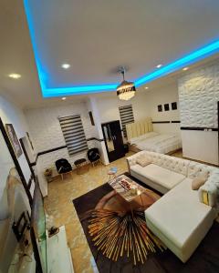 a living room with a couch and a table at Luxury studio apartment in Accra