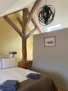 a bedroom with a bed with a tree on the wall at Lilau - Villa de charme avec parking et jardin près de Chantilly in Gouvieux