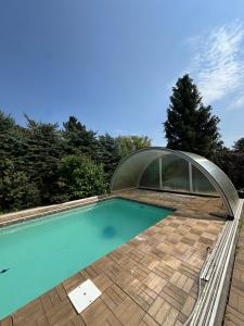 a swimming pool with a glass house on a roof at Chalet Parížovce with swimming pool and mountain views in Liptovský Trnovec