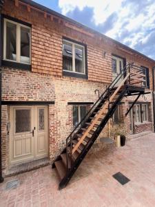 a brick building with a staircase on the side of it at appartement chaleureux in Honfleur