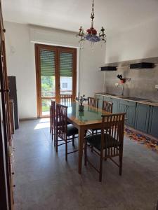 a dining room with a table and chairs in a kitchen at FasHion HOme in Ameglia +36 photos