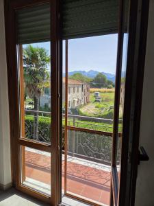 an open door to a balcony with a view at FasHion HOme in Ameglia