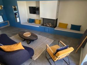 a living room with two chairs and a fireplace at Lilau - Villa de charme avec parking et jardin près de Chantilly in Gouvieux