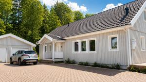 a house with a car parked in front of it at Villa Kaxberg in Södertälje